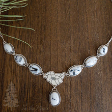 Load image into Gallery viewer, Necklace with silver magnolia flower and 7 white buffalo turquoise stones on dark wood background bridal necklace