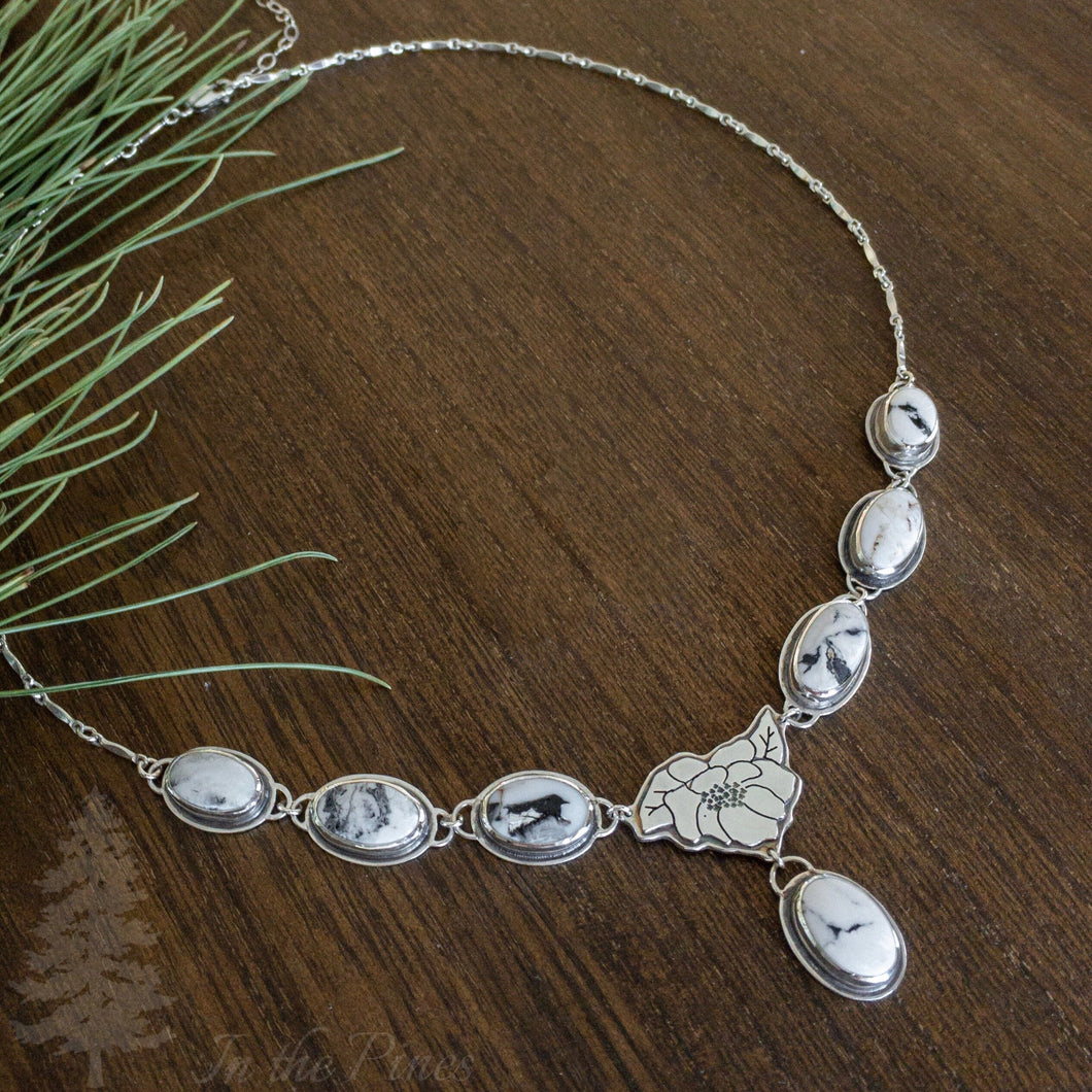 Necklace with silver magnolia flower and 7 white buffalo turquoise stones on dark wood background bridal necklace